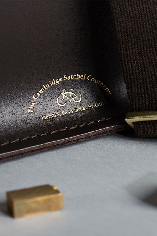 The Cambridge Satchel Company hot foil embossed logo beside letterpress stamps