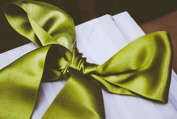 Present wrapped with a green bow