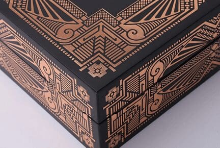 A luxurious black box featuring an intricate design, created using a hot foil printing technique.