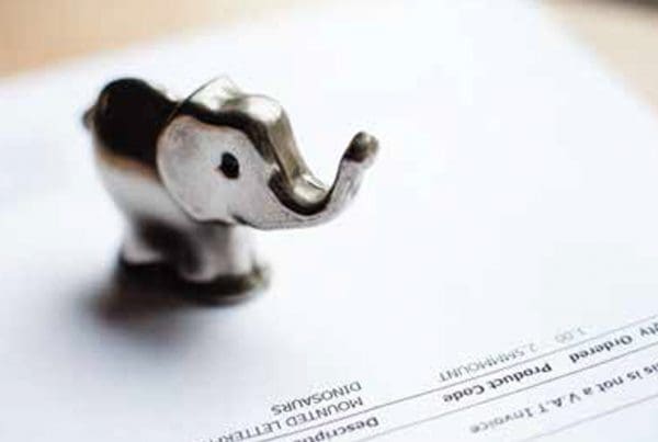 small gold elephant standing on product invoice