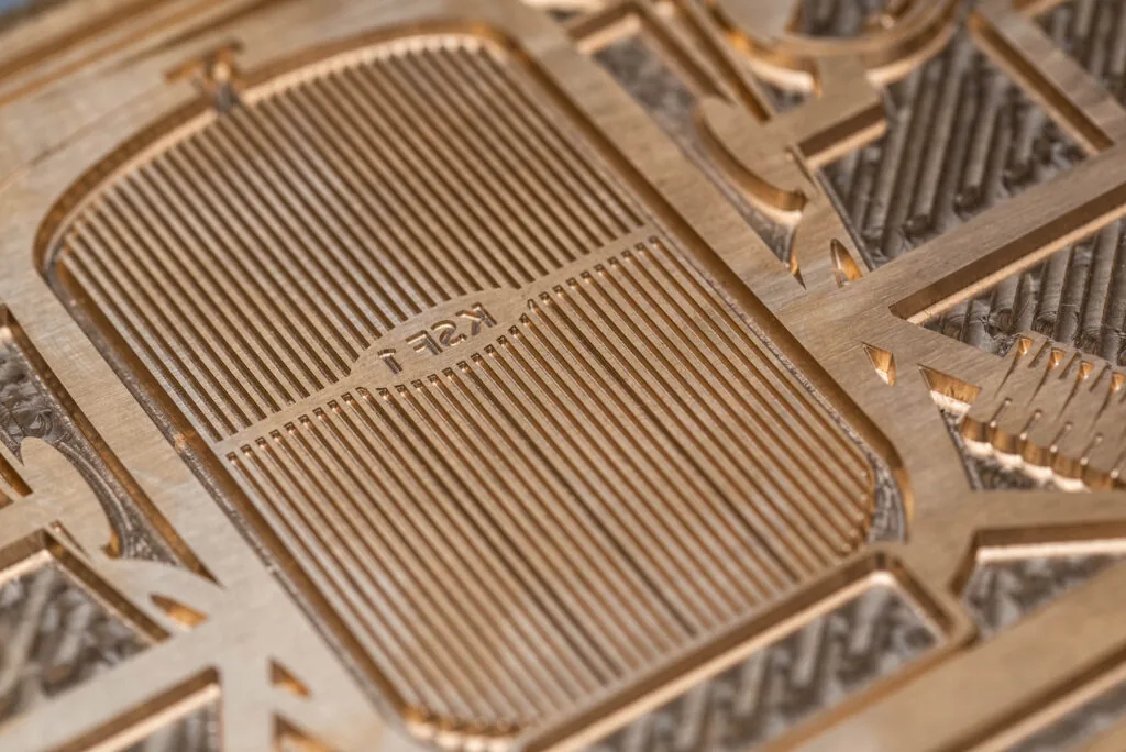 Close-up of an engraved brass hot foil die