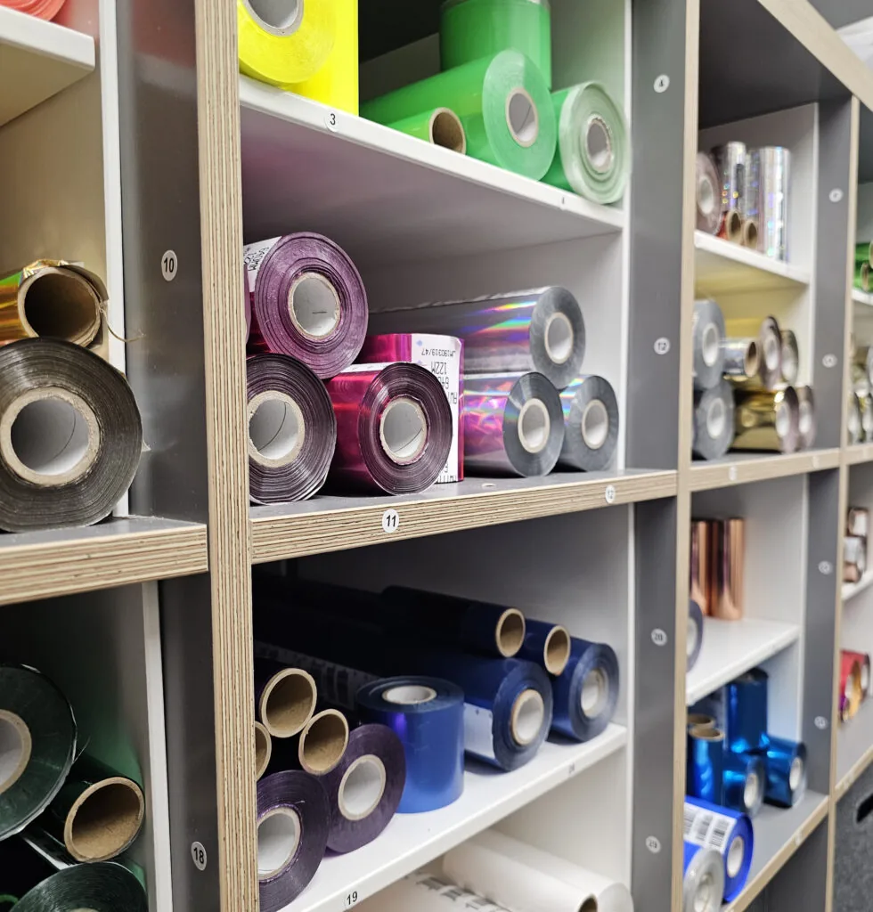 Shelves stacked with rolls of stamping foil